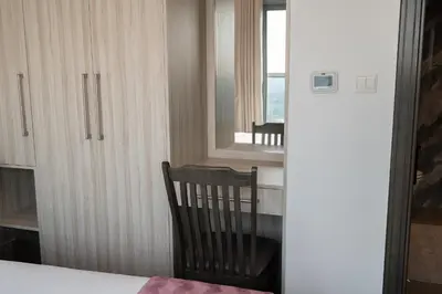 a room with a table and a chair and a window at Elegant 2BR - Top Amenities - Elite Business Bay in Dubai