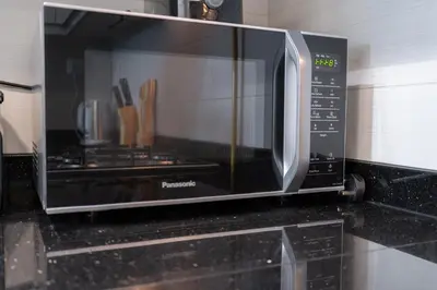 a microwave oven sitting on top of a kitchen counter at Elegant 2BR - Top Amenities - Elite Business Bay in Dubai