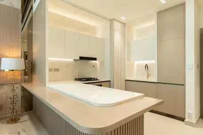 a kitchen with white cabinets and a counter top at The Royale Beige Jacuzzi Suite 36 2-4 I JVC I Dar Oasis in Dubai