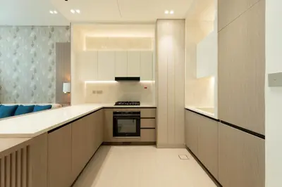 a kitchen with white cabinets and a stove at The Royale Beige Jacuzzi Suite 36 2-4 I JVC I Dar Oasis in Dubai