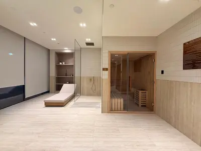 a living room with a couch and a glass door at The Royale Beige Jacuzzi Suite 36 2-4 I JVC I Dar Oasis in Dubai