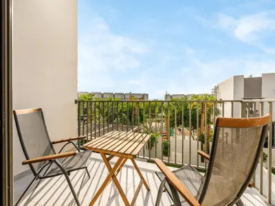 a balcony with two chairs and a table at LUX 4BD Villa, PS5, Minutes from Golf & Downtown in Dubai