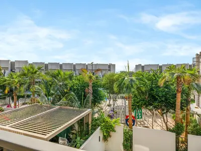 a view from the balcony of a resort with palm trees at LUX 4BD Villa, PS5, Minutes from Golf & Downtown in Dubai