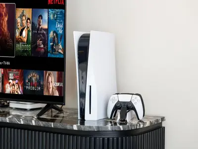 a table with a television and a video game controller at LUX 4BD Villa, PS5, Minutes from Golf & Downtown in Dubai