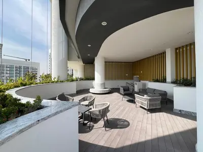 a lobby of a building with chairs and tables at Deluxe 1BR with maid's room, 10 min to Downtown in Dubai