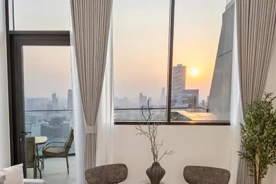a room with a window with a view of the city at Private Pool - Amazing 1BR Apartment in JVC in Dubai