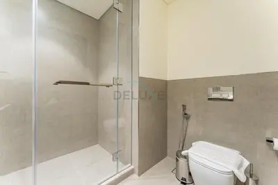 a bathroom with a shower and a toilet at High-Floor Luxury 2BR with Full Burj Khalifa & Fountain Views, Seamless Access to Dubai Mall and Burj Park, Grande, Downtown Dubai by Deluxe Holiday Homes in Dubai