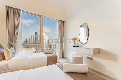 a bedroom with two beds and a large window at High-Floor Luxury 2BR with Full Burj Khalifa & Fountain Views, Seamless Access to Dubai Mall and Burj Park, Grande, Downtown Dubai by Deluxe Holiday Homes in Dubai