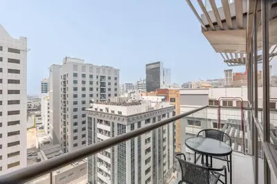 a balcony with two chairs and a table at StayShort - Roomy 2BR in Al Barsha with Balcony - Sleeps 4 in Dubai
