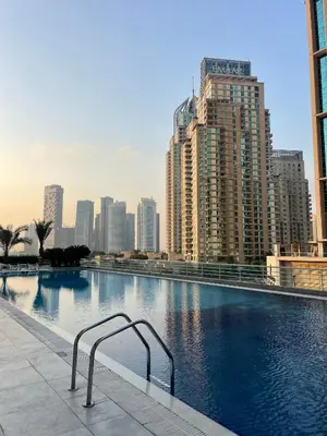 a large swimming pool in a city with tall buildings at Casa Marina - great views & pool, fully equipped in Dubai