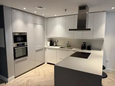 a kitchen with white cabinets and a stove top oven at Casa Marina - great views & pool, fully equipped in Dubai