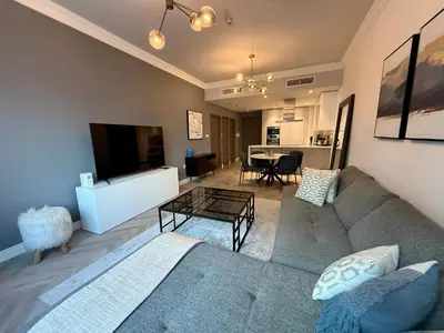 a living room with a couch and a table at Casa Marina - great views & pool, fully equipped in Dubai