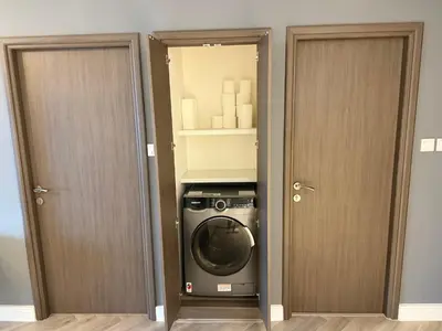 a washing machine in a room with two doors at Casa Marina - great views & pool, fully equipped in Dubai