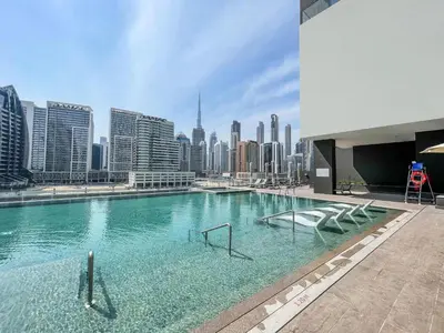 a swimming pool with a city skyline in the background at Premium 15 Northside Residences in Business Bay, Close to Downtown Dubai & Burj Khalifa by Stayfinity in Dubai