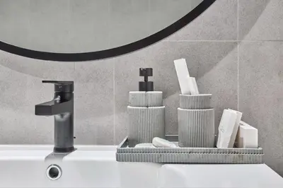 a bathroom sink with a faucet and toiletries at Premium 15 Northside Residences in Business Bay, Close to Downtown Dubai & Burj Khalifa by Stayfinity in Dubai
