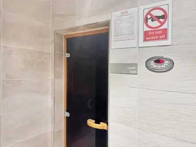 a door to a bathroom with a sign on the wall at Luxury High Floor 4 Bedrooms with Marina Views by Stayfinity in Dubai
