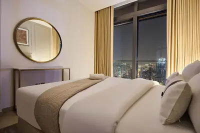 a bedroom with a white bed and a mirror at Luxury High Floor 4 Bedrooms with Marina Views by Stayfinity in Dubai