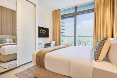 a bedroom with a large bed and a large window at Luxury High Floor 4 Bedrooms with Marina Views by Stayfinity in Dubai