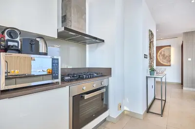 a kitchen with a stove and a counter top at Luxury High Floor 4 Bedrooms with Marina Views by Stayfinity in Dubai