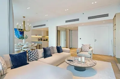 a living room with a couch and a table at Luxurious 2BR Breathtaking Huge Pool & Sea Views in Dubai
