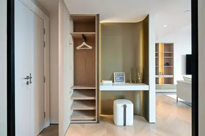 a room with a closet with a table and a stool at Luxurious 2BR Breathtaking Huge Pool & Sea Views in Dubai