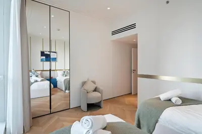 a bedroom with two beds and a mirror at Luxurious 2BR Breathtaking Huge Pool & Sea Views in Dubai