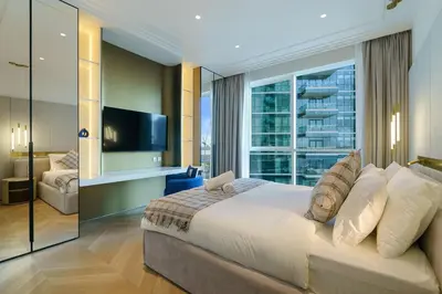 a bedroom with a large bed and a large window at Luxurious 2BR Breathtaking Huge Pool & Sea Views in Dubai