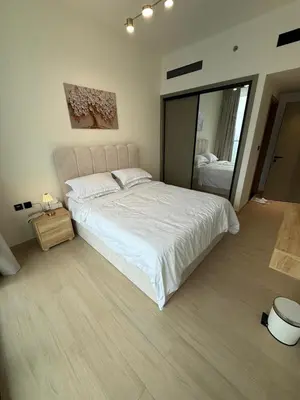 a bedroom with a large white bed and a mirror at Luxury 1BR Apartment In Binghatti Corner, High Floor In JVC in Dubai