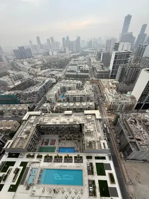 an aerial view of a building in a city at Luxury 1BR Apartment In Binghatti Corner, High Floor In JVC in Dubai