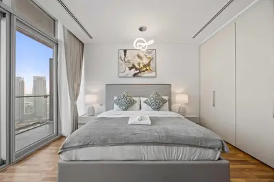 a bedroom with a large bed and a large window at YOUR STAY CORPORATE RESIDENCES DIFC Burj Daman in Dubai