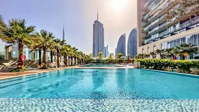 a swimming pool in a city with palm trees and buildings at YOUR STAY CORPORATE RESIDENCES DIFC Burj Daman in Dubai