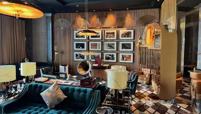 a lobby with a blue couch and a mirror at YOUR STAY CORPORATE RESIDENCES DIFC Burj Daman in Dubai