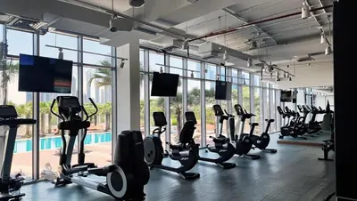 a gym with a lot of treadmills and ellipticals at YOUR STAY CORPORATE RESIDENCES DIFC Burj Daman in Dubai