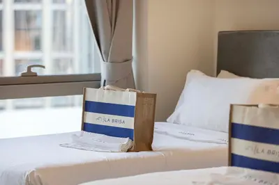 two bags sitting on top of a bed at Luxury 2BR Downtown Dubai, Grande Signature with Stunning Burj Khalifa and Dubai Opera Views, steps to Dubai Mall by La Brisa in Dubai