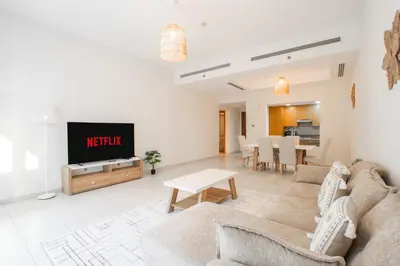 a living room with a couch and a tv at Nivis find- Bay square -1 BHK in Dubai