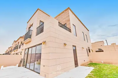 a large brick building with large windows on it at Luxury Elie Saab 3BR Villa in Jasmine Lane in Dubai