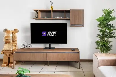 a tv sitting on a table in a living room at Modern 1BR in Dubai Marina with Balcony Gym & Pool in Dubai