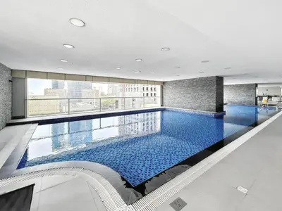 a large swimming pool in a building at Modern 1BR in Dubai Marina with Balcony Gym & Pool in Dubai