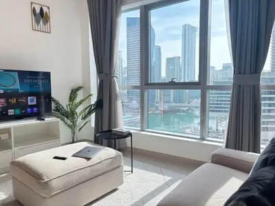 a living room with a view of a city at 810 Elegant Marina View Apartment Near Tram, Dining & Nightlife, Bay Cental in Dubai
