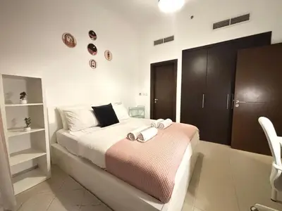 a bedroom with a bed with two towels on it at 810 Elegant Marina View Apartment Near Tram, Dining & Nightlife, Bay Cental in Dubai