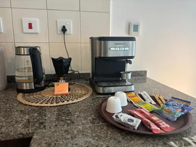 a counter top with a coffee maker on a counter at 810 Elegant Marina View Apartment Near Tram, Dining & Nightlife, Bay Cental in Dubai