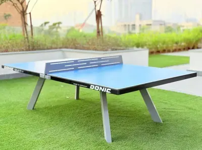 a ping pong table sitting on top of grass at Nature luxe estudio Dubai in Dubai
