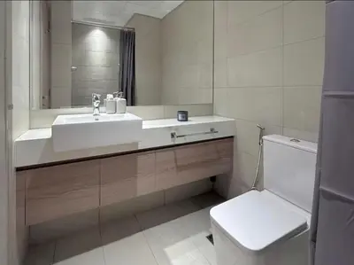 a bathroom with a sink and a toilet and a mirror at Nature luxe estudio Dubai in Dubai