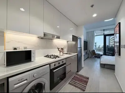 a kitchen with a sink and a stove top oven at Nature luxe estudio Dubai in Dubai