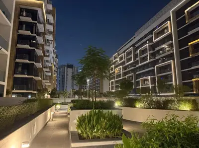 an apartment complex at night with buildings at Nature luxe estudio Dubai in Dubai