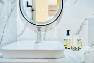 a bathroom with a white sink and a mirror at PVH - Dubai Gate 1 - Cozy Central Studio in JLT in Dubai