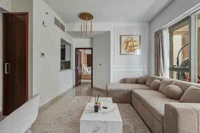 a living room with a couch and a table at Downtown 1BR Full Burj Khalifa & Fountain Views in Dubai