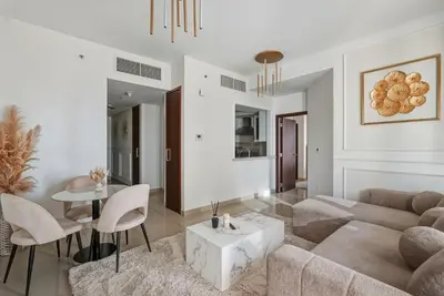 a living room with a couch and a table at Downtown 1BR Full Burj Khalifa & Fountain Views in Dubai