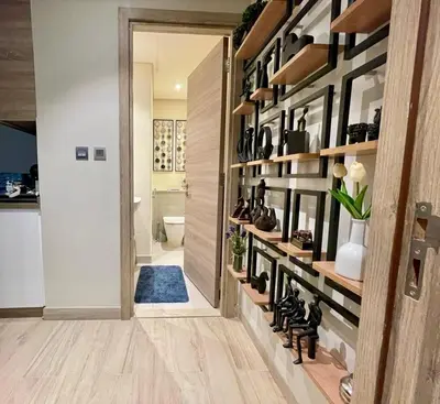 a hallway with a wall of shelves with shoes at Luxury Apartment Marina in Dubai