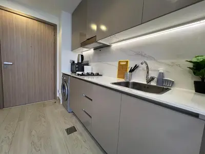 a kitchen with a sink and a dishwasher at Urban SkyView Apartment Near Downtown Dubai in Dubai